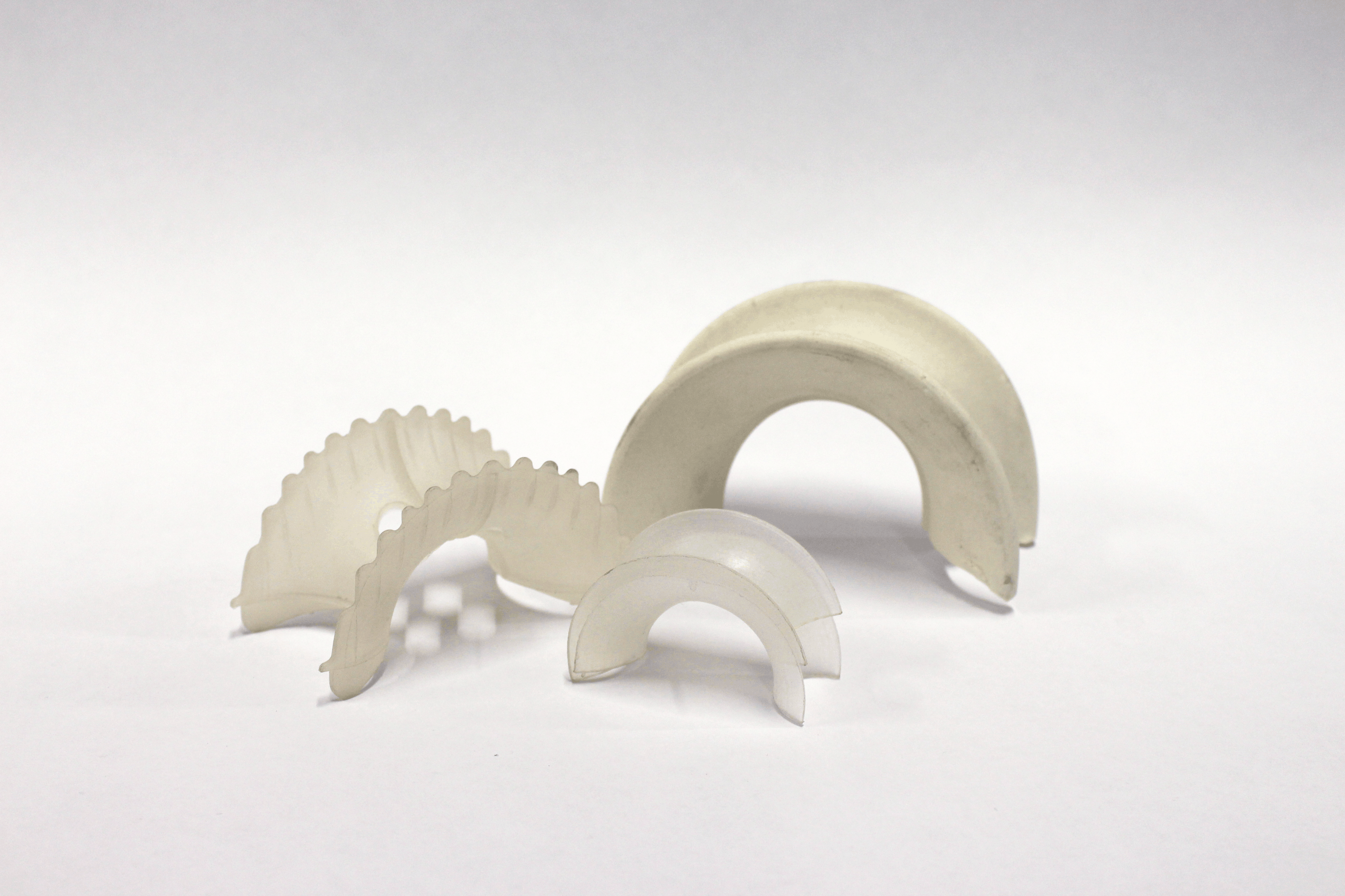 Random packing intalox saddles on white background